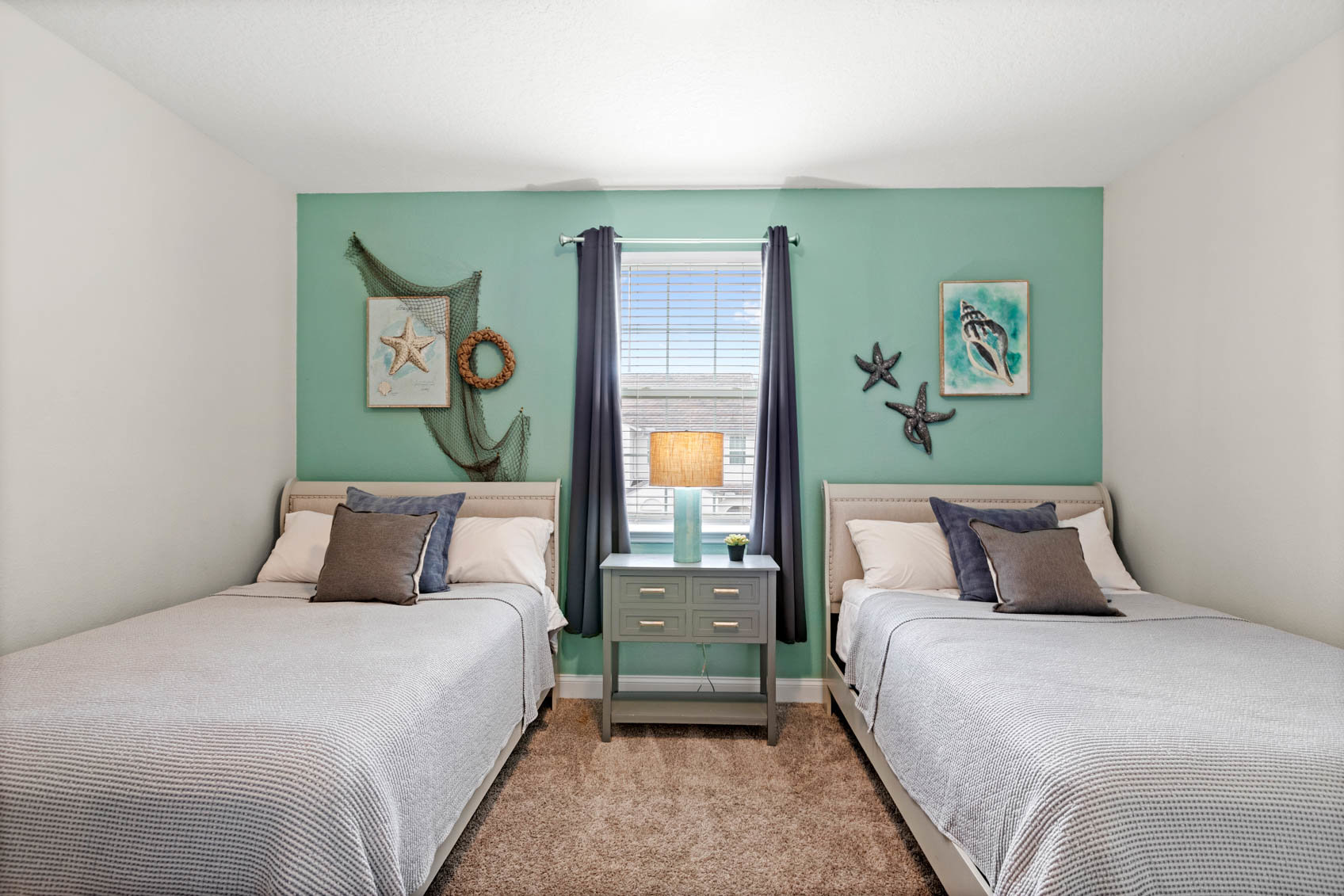 Bedroom with two beds and sea theme